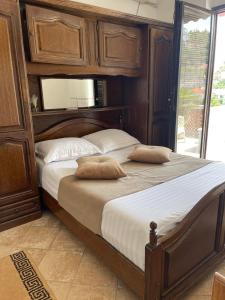 a bedroom with two twin beds with wooden cabinets at Apartments Milla in Ulcinj
