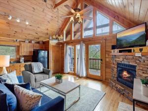 a living room with a blue couch and a fireplace at Breathtaking views of the Smokies, 3 mins to Gatlinburg in Gatlinburg