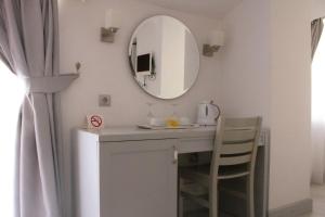 a bathroom with a sink and a mirror on the wall at Aktaş Butik Hotel in Mugla