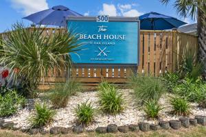 a sign for the beach house and gulf island at The Beach House at Oak Island by Carolina Resorts in Oak Island