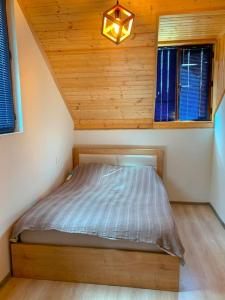 a small bedroom with a bed in a attic at Racha Twins in Nikortsminda
