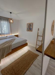 a bedroom with a bed and a window and a chair at Mawa Cottage in Ulcinj