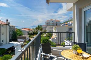 a balcony with a table and a view of a city at Emilia Lofts in Tučepi