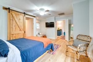 a bedroom with a bed and a sliding barn door at Cute Georgetown Villa Less Than 1 Mi to Historic District in Georgetown
