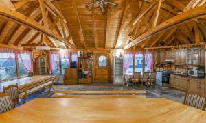 a dining room with a large wooden table in a cabin at Prenočište Villa Ivanić in Josipovac