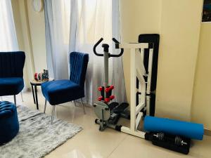 Habitación con gimnasio con cinta de correr y sillas en Casa Bonita Pimentel, 