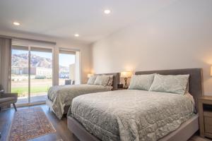 a bedroom with two beds and a window at South Zion Inn and Suites in Hildale