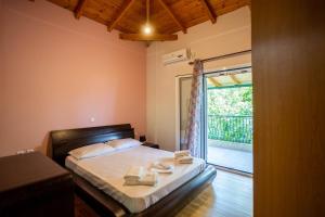a bedroom with a bed and a sliding glass door at Villa Olive in Kalamata