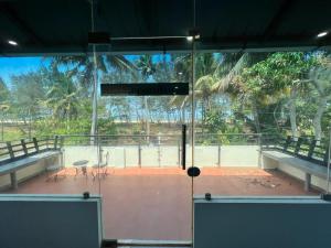 a view of a tennis court from the inside of a building at Sunshine Beach Villa - Kuzhuppilly in Cherai Beach