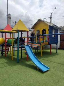 a group of children playing on a playground at CABAÑA MANANTIAL DE DIOS in Turbo