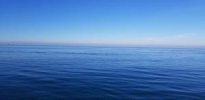 a large body of water with a boat in the distance at MIDIA Guest House in K'obulet'i
