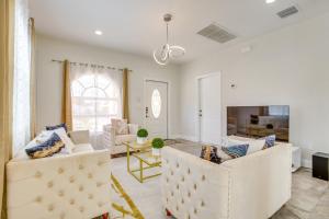 a living room with two white chairs and a couch at Stylish Fort Lauderdale Home 5 Mi to Beach! in Fort Lauderdale