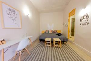 a bedroom with a bed and a table and chairs at ONCE UPON A TIME IN MEXICO - KASA KAKTUS in Mexico City