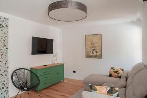 a living room with a couch and a tv at Apartment Vito in Omiš