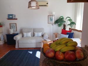 ヴィラ・ノヴァ・デ・ミルフォンテスにあるLagoa azul guest houseのリビングルーム(バナナとリンゴの入ったボウル付)