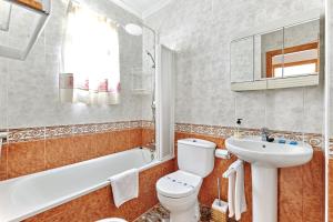 a bathroom with a white toilet and a sink at Espanhouse Alina in Orihuela Costa +30 photos