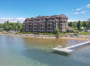 a building on a dock in the water with a bench at Tamarack Lodge in Traverse City