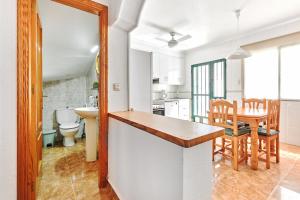 a kitchen and dining room with a table and chairs at Espanhouse Sonia in La Zenia Playas de Orihuela in Orihuela +35 photos