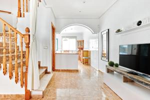 a living room with a fireplace and a television at Espanhouse Sonia in La Zenia Playas de Orihuela in Orihuela