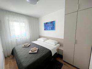 Posteľ alebo postele v izbe v ubytovaní Apartman Solis
