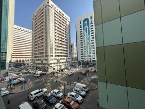 a city with cars parked in a parking lot at Private Room Shared Apartment Flat31-R1 in Abu Dhabi