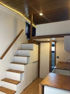 a staircase in a tiny house with a kitchen at Zu Tiny House Hotel & Restaurant in Urla