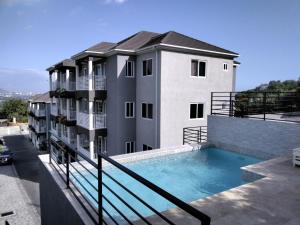 a apartment building with a swimming pool on the balcony at Lavue in Kingston