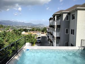 a view from the balcony of a building with a swimming pool at Lavue in Kingston