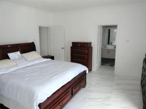 a bedroom with a large bed and a bathroom at Lavue in Kingston +32 photos