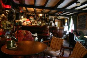 a pub with a table and chairs and a bar at Ty Gwyn Hotel in Betws-y-coed