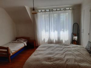 a bedroom with a large bed and a window at spacieux T5 Quimper centre in Quimper