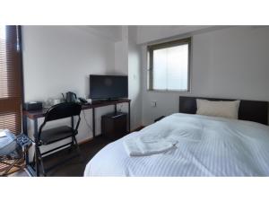 a bedroom with a bed and a desk and a chair at 8HOTEL CHIGASAKI - Vacation STAY 87519v in Chigasaki