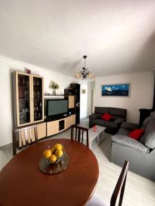 a living room with a table and a couch at Casa MIJAS PUEBLO La Villa Nueva in Mijas