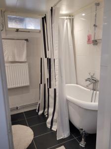 a bathroom with a tub and a sink and a bath tub at lägenhet i Borgholms villa in Borgholm +43 photos