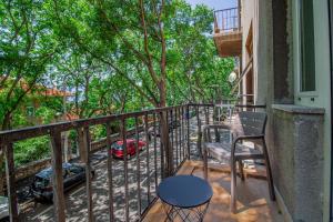 a balcony with a table and a chair and a car at Apartments Euphoria East in Rijeka