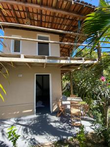 a view of the front of a house with a patio at Pousada Amora Caraiva in Caraíva