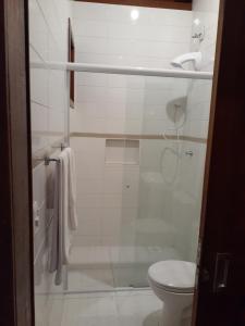 a bathroom with a shower and a toilet at Por do Sol in Florianópolis
