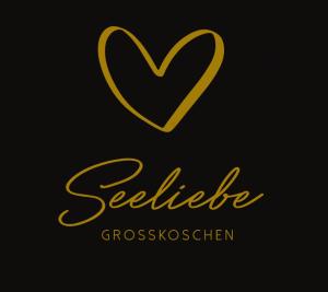 a gold logo with a heart on a black background at Seeliebe mit Sauna und nur 50 mtr. bis zum Strand in Senftenberg