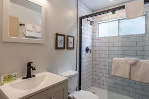 a bathroom with a sink and a toilet and a mirror at Tyrolean Village 6 2 Bedroom 1 and a Half Bath Sleeps 6 Walk to Lift Steps to town shuttle in Mammoth Lakes +24 photos