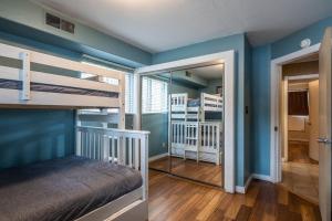a bedroom with blue walls and bunk beds at Tyrolean Village 6 2 Bedroom 1 and a Half Bath Sleeps 6 Walk to Lift Steps to town shuttle in Mammoth Lakes