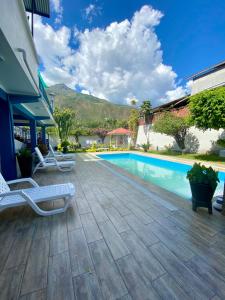 a swimming pool with two lounge chairs next to a house at Casa Plaza Bolívar in Quillabamba
