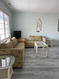 a living room with a couch and a table at Crystal Sands Phila Ave in Ocean City