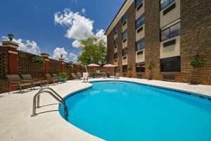 a large swimming pool in front of a building at Best Western Plus Pineville-Charlotte South in Charlotte