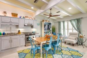 a kitchen with a wooden table and blue chairs at Pet-Friendly Jekyll Island Abode - Walk to Beach! in Jekyll Island