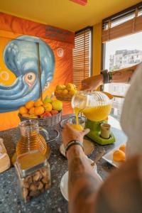 a person is making a drink in a blender at Best Western Linko Hôtel in Aubagne