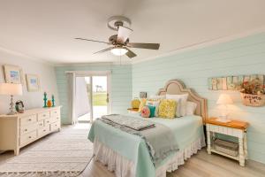 a bedroom with a bed and a ceiling fan at Pet-Friendly Jekyll Island Abode - Walk to Beach! in Jekyll Island