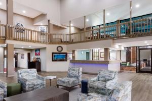 a lobby of a hospital with chairs and a table at SureStay Plus Hotel by Best Western Greenwood in Greenwood