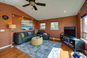 a living room with a couch and a tv at Waterfront Birch Bay Rental - Walk to Beach! in Blaine