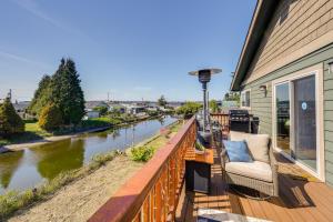 a balcony with a couch and a view of a river at Waterfront Birch Bay Rental - Walk to Beach! in Blaine