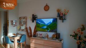 a living room with a flat screen tv on a wall at Boho Chic Studio Apartment on Yas with Pool Access in Abu Dhabi